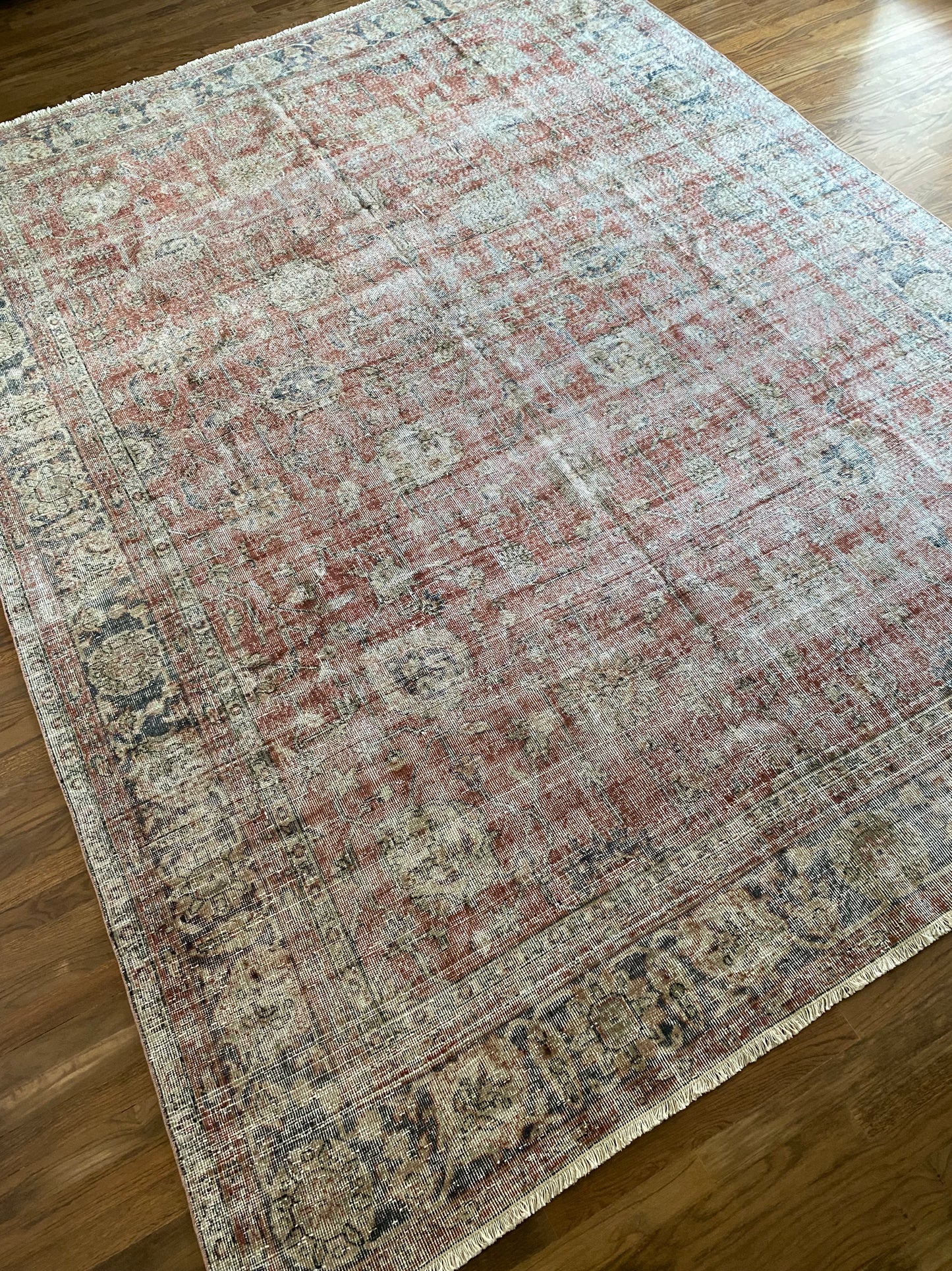 Faded red floral vintage rug hand knotted wool. 