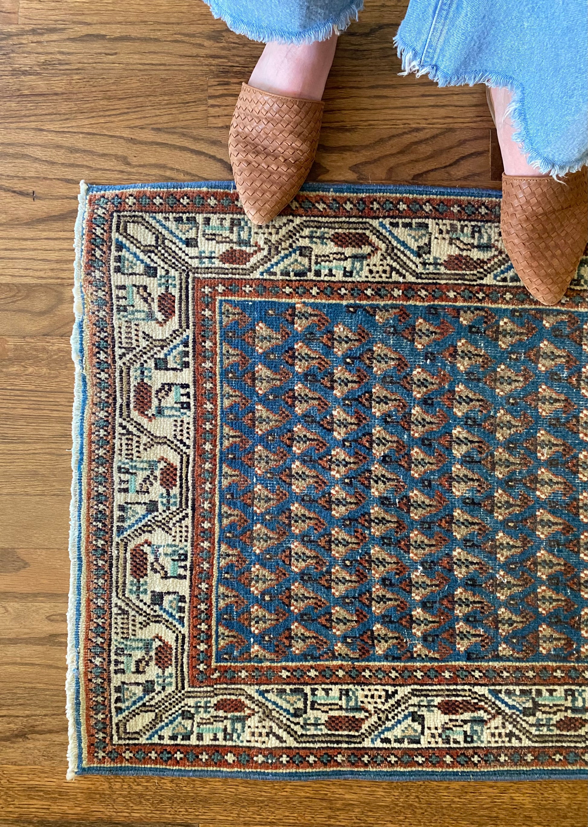 Close up antique rug showing blue tones and texture