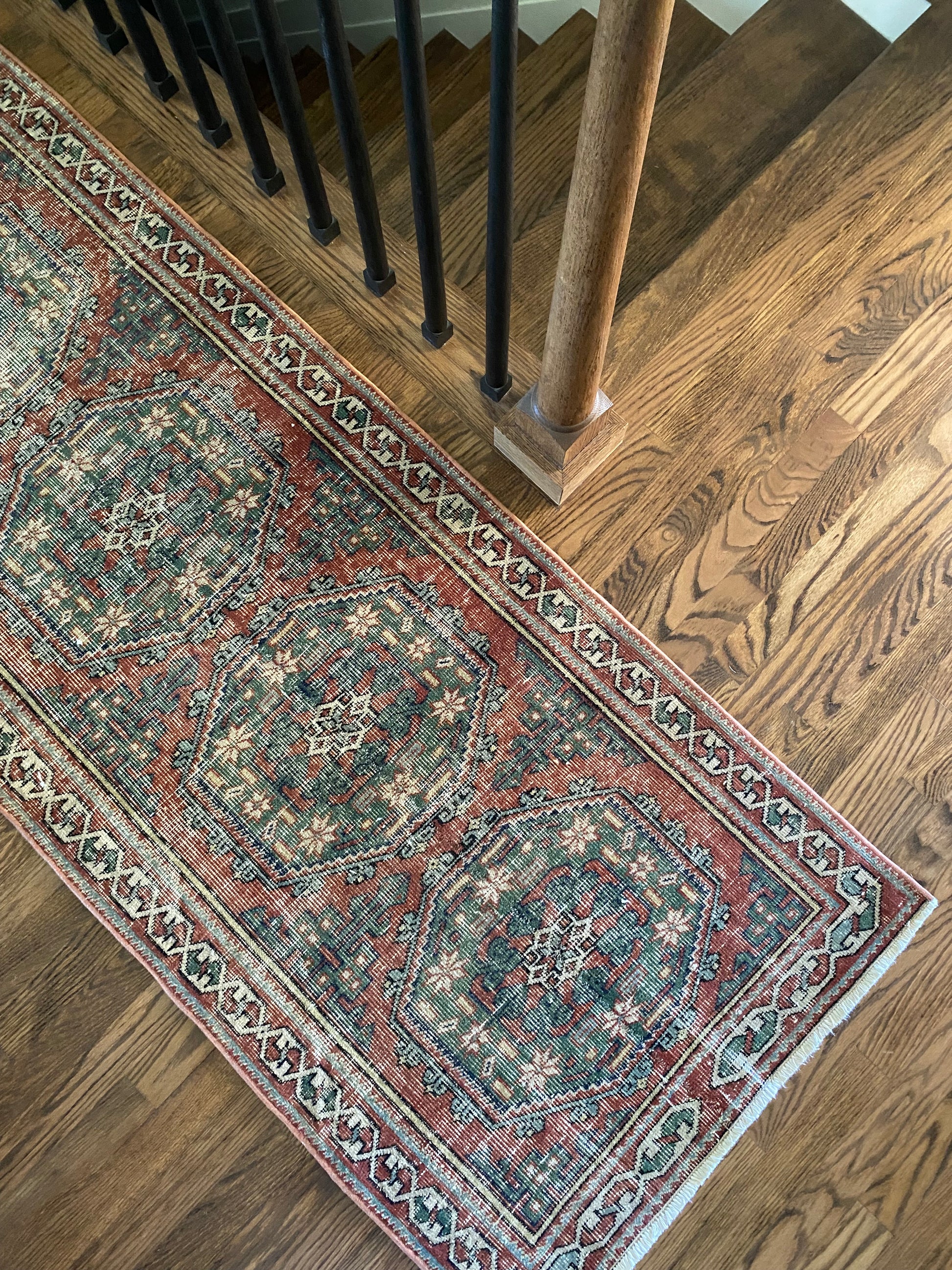 Faded red and green runner rug soft tones styling