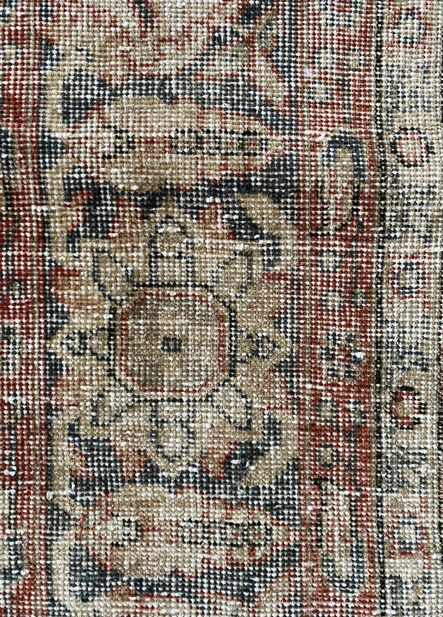 Close up vintage Turkish rug showing texture and wear. 