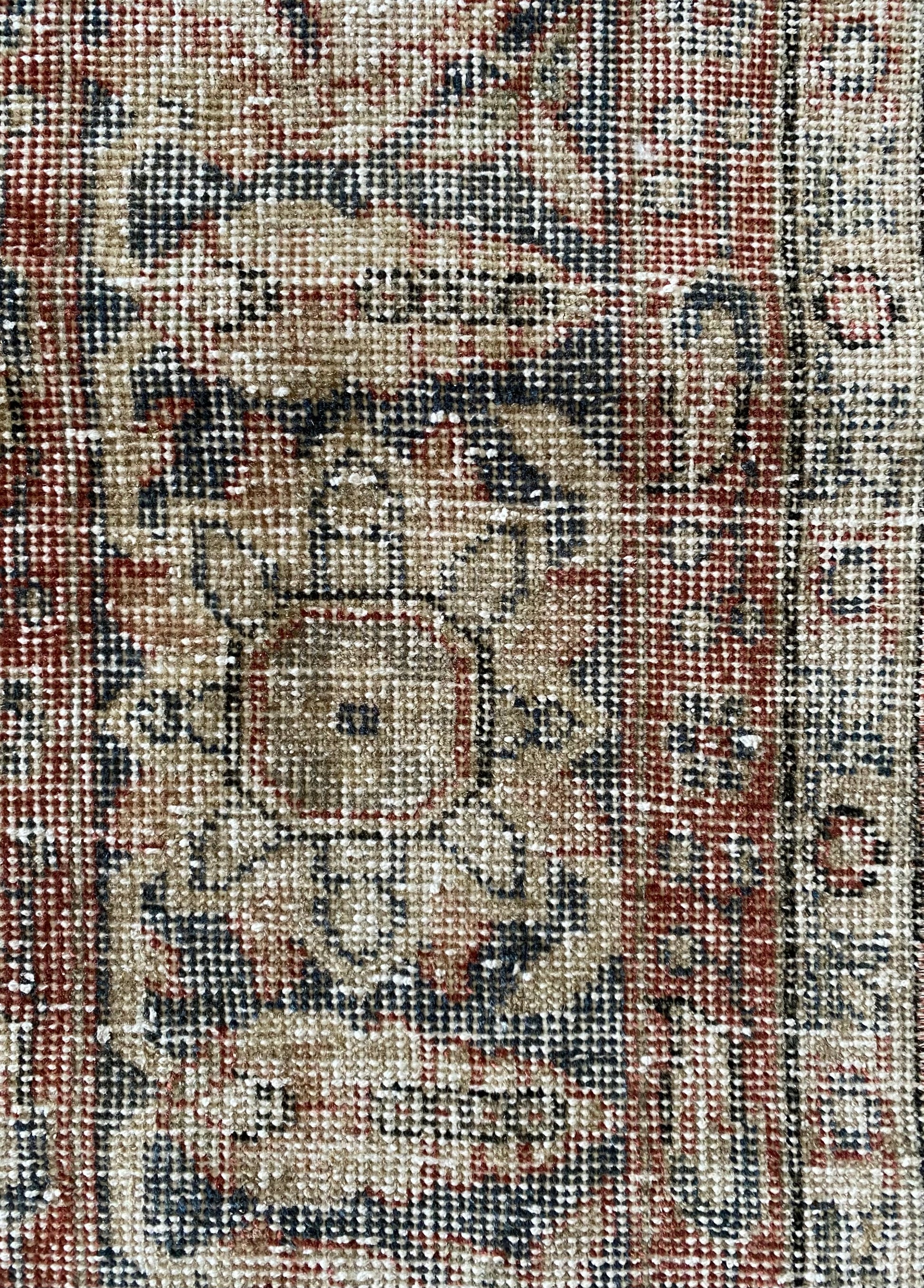 Close up vintage Turkish rug showing texture and wear. 